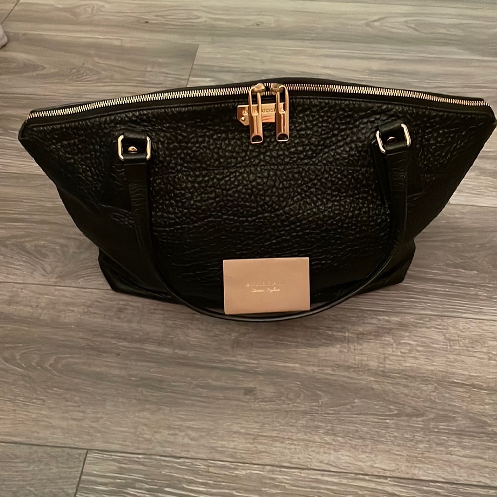 Authentic Burberry pebble leather black tote with gold hardware.